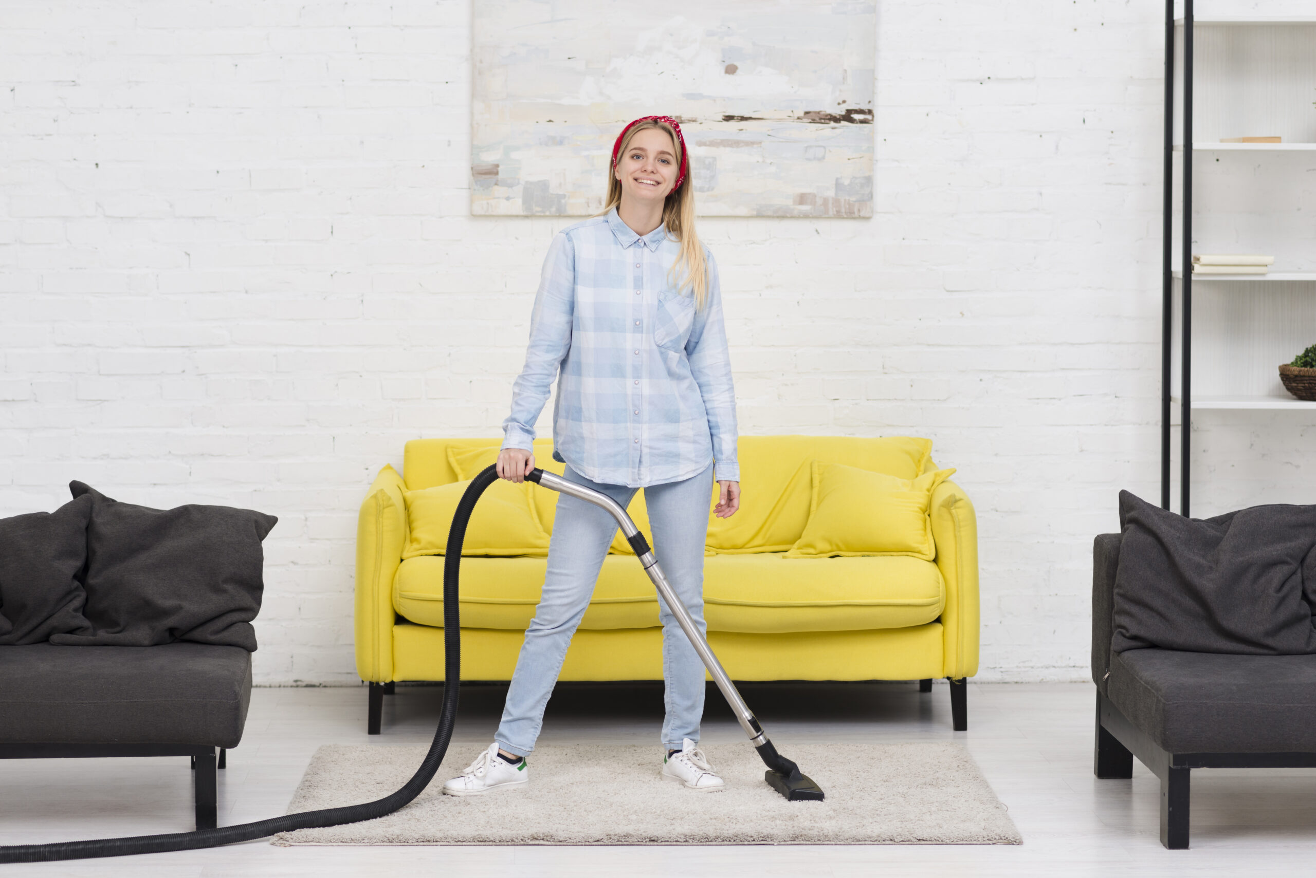 woman cleaning with vacuum cleaner scaled